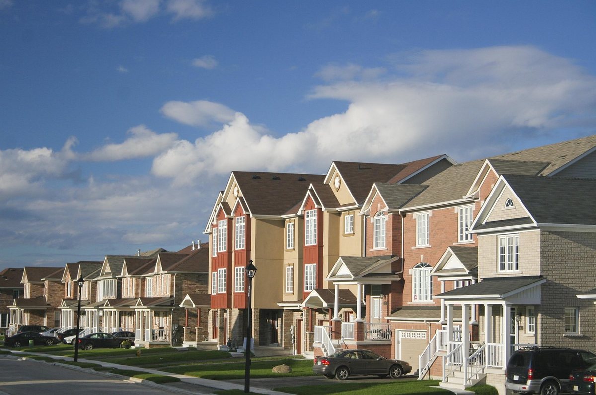 A quiet suburban street of townhouses, the kind of neighborhood HelperWebs serves